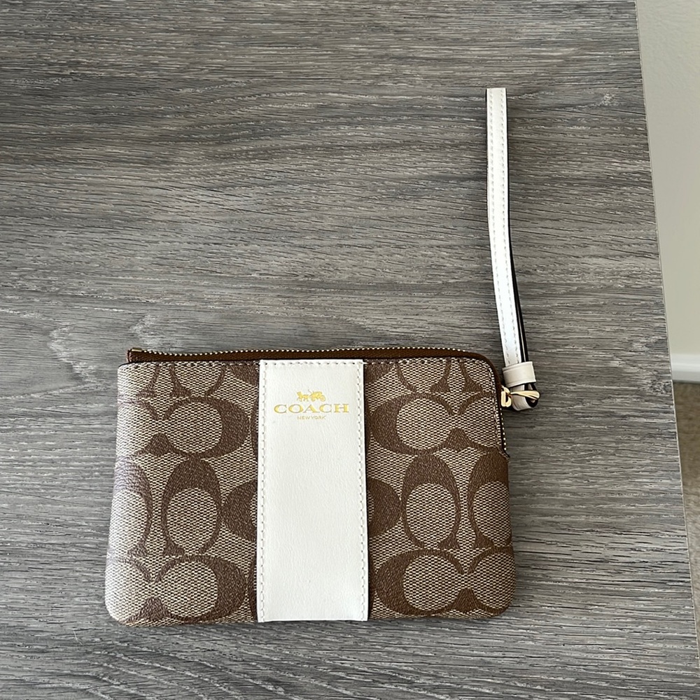 Coach brown and cream wristlet. 6 in (W) 4 in (H)